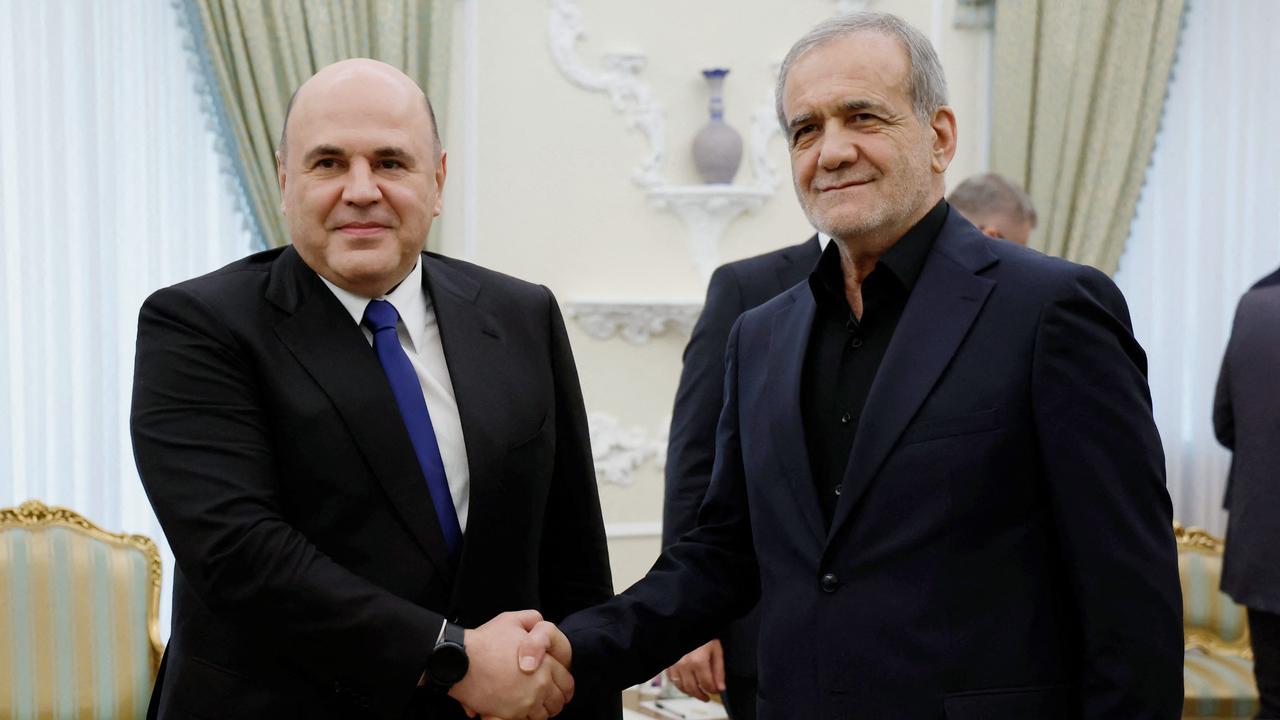 Iranian President Masoud Pezeshkian (R) shakes hands with Russian Prime Minister Mikhail Mishustin in Tehran on September 30. Picture: AFP