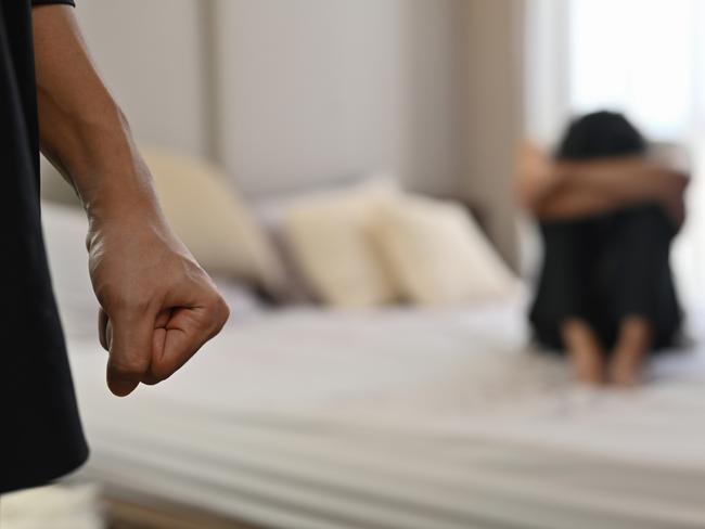 istock generic:  woman, abuse, DV, domestic violence, harassment, sexual harassment.   Selective focus on the fist male with crying man sits on a bed as the background, Violence, Love and relationships, Gay couple, sexual harassment concept. . Picture: istock