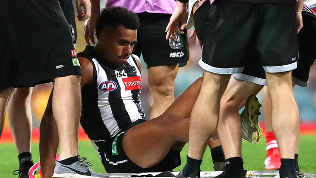 Quaynor looks down at his leg after copping the nasty gash. Picture: Jono Searle