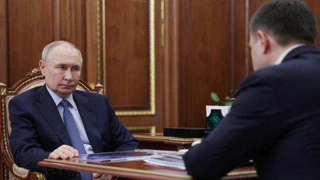 Russia's President Vladimir Putin meets with Promsvyazbank CEO Pyotr Fradkov at the Kremlin in May.