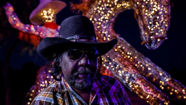 Another $5 million in funding for the Parrtjima festival in Alice Springs has been announced in today’s NT Budget. Artist David Wallace is seen here with his work “Language of Stockman”. Picture: Parrtjima/NTMEC