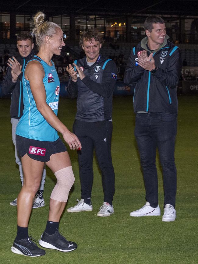 Erin Phillips walks through the guard of honour at Port’s first training session. Picture Mark Brake