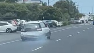 The early model white Subaru driving on two blown tyres before crashing into a median divider on Sheridan St on Tuesday afternoon. Picture: Amu SyluMay