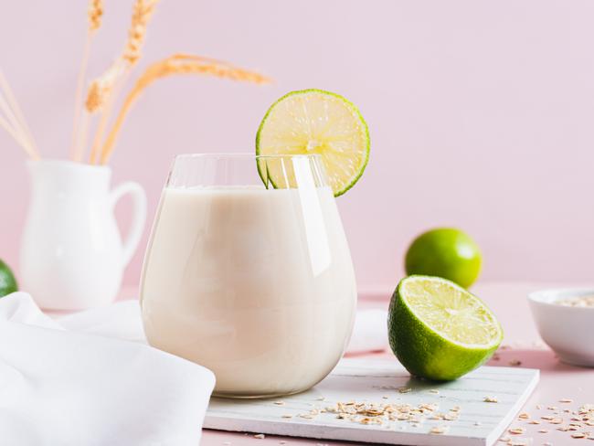 Homemade oatzempic drink of oat milk and lime in a glass on the table