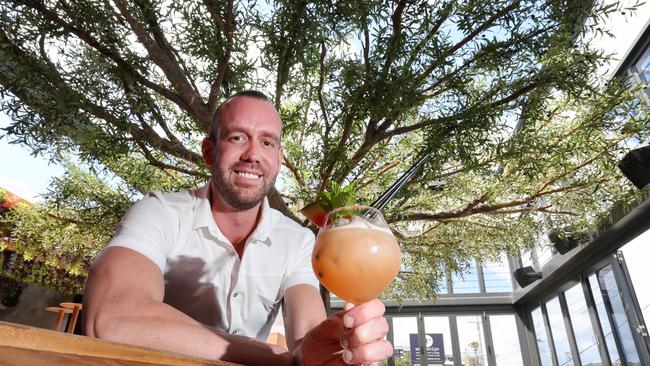 Juju in Nobby Beach opened earlier this year. Owner Trent Redman is pictured upstairs enjoying a cocktail under the venue tree - he is opening a new nightclub too in Surfers Paradise. Picture Glenn Hampson