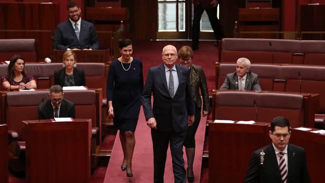 Jim Molan returns to the Senate chamber, flanked by Concetta Fierravanti-Wells and Linda Reynolds. Picture: Kym Smith