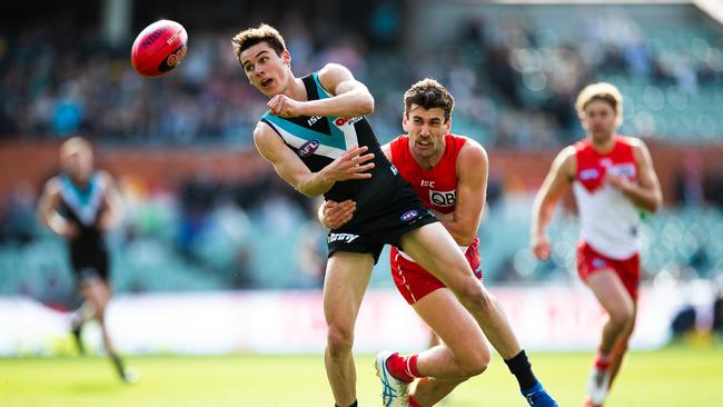 Port’s Connor Rozee gets a handball away against Sydney in front of a small Adelaide Oval crowd this season. Picture: Daniel Kalisz/Getty Images