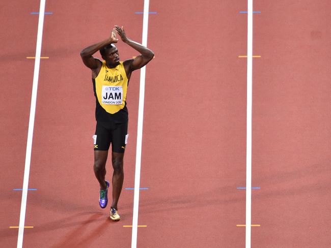 But he shrugged them off to walk gingerly across the line, saluting the crowd in his final race. Picture: AFP