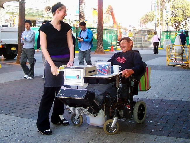 Claire Smith makes a donation to tireless Shepherd Centre worker Bourke Gibbons on The Corso, Manly, in 2006. Picture: Supplied