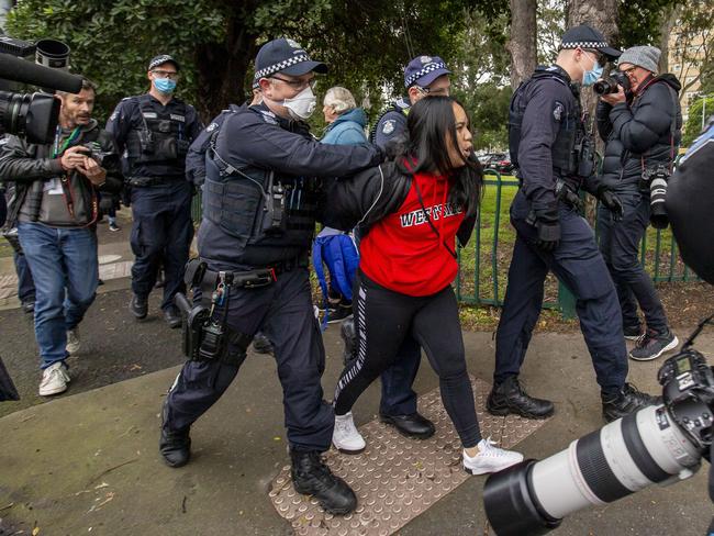 Police detain a woman in Flemington before releasing her. Picture: Tim Carrafa