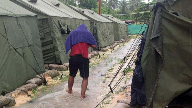 This file undated photo obtained from the Refugee Action Coalition on in 2014 shows a man walking between tents at Australia’s regional processing centre on Manus Island in Papua New Guinea.