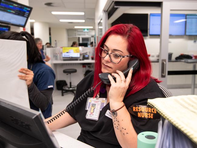 Associate Nurse Manager Angela Weber answers a phone call at the front desk.