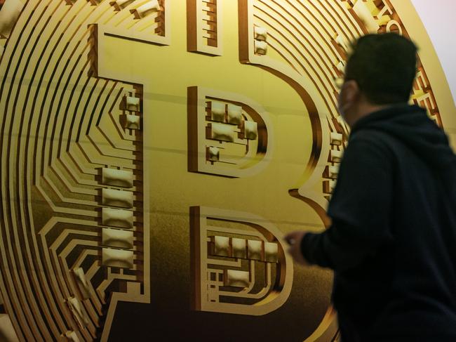 HONG KONG, CHINA - FEBRUARY 15: Pedestrians walk past an advertisement displaying a Bitcoin cryptocurrency token on February 15, 2022 in Hong Kong, China. Cryptocurrencies are gaining popularity worldwide as investors seek to diversify into the new asset class despite wild swings in the valuations of assets like Bitcoin and Ethereum in the first weeks of the year. Buying and selling crypto is becoming common in many places, like Hong Kong, where regulators have so far avoided using a heavy hand to manage crypto platforms. (Photo by Anthony Kwan/Getty Images)