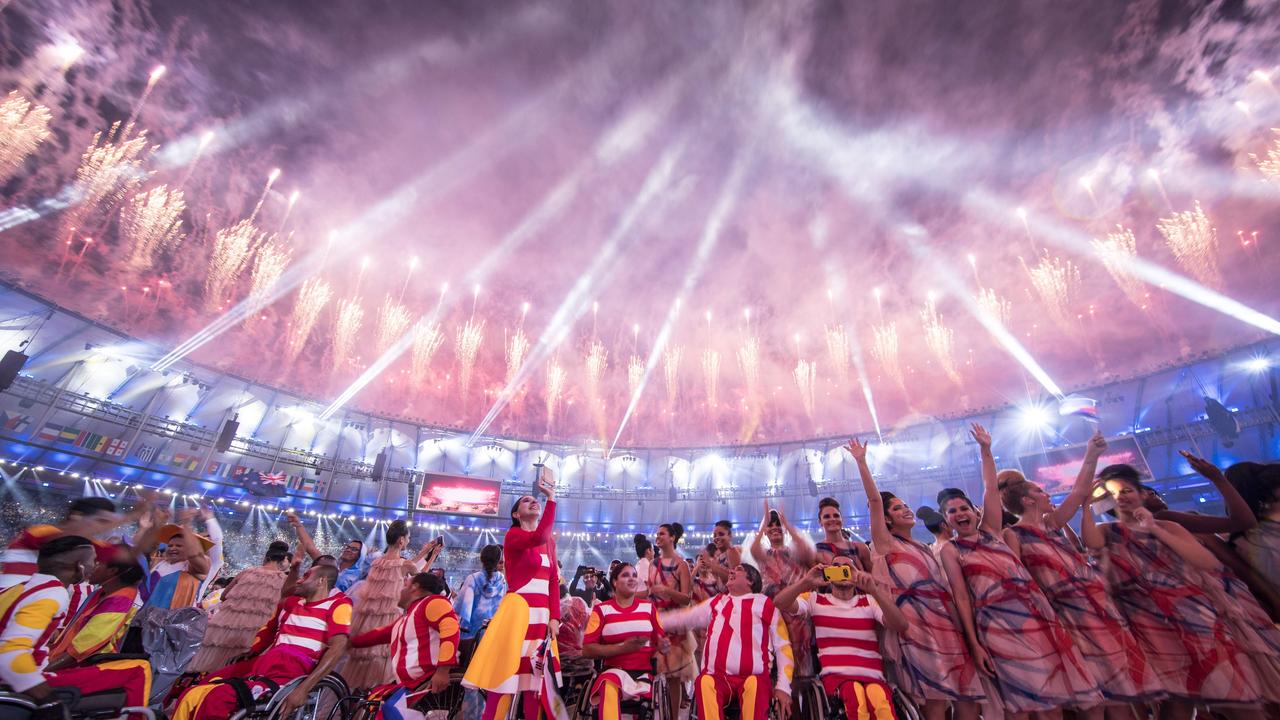 TOPSHOT - Participants react under fireworks during the opening ceremony of the Rio 2016 Paralympic Games at the Maracana stadium in Rio de Janeiro on September 7, 2016. / AFP PHOTO / YASUYOSHI CHIBA