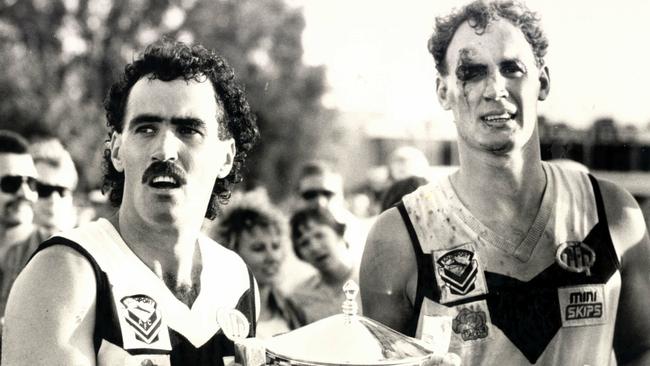 Southport captain Zane Taylor, left, with a bloodied Gary Dempsey.