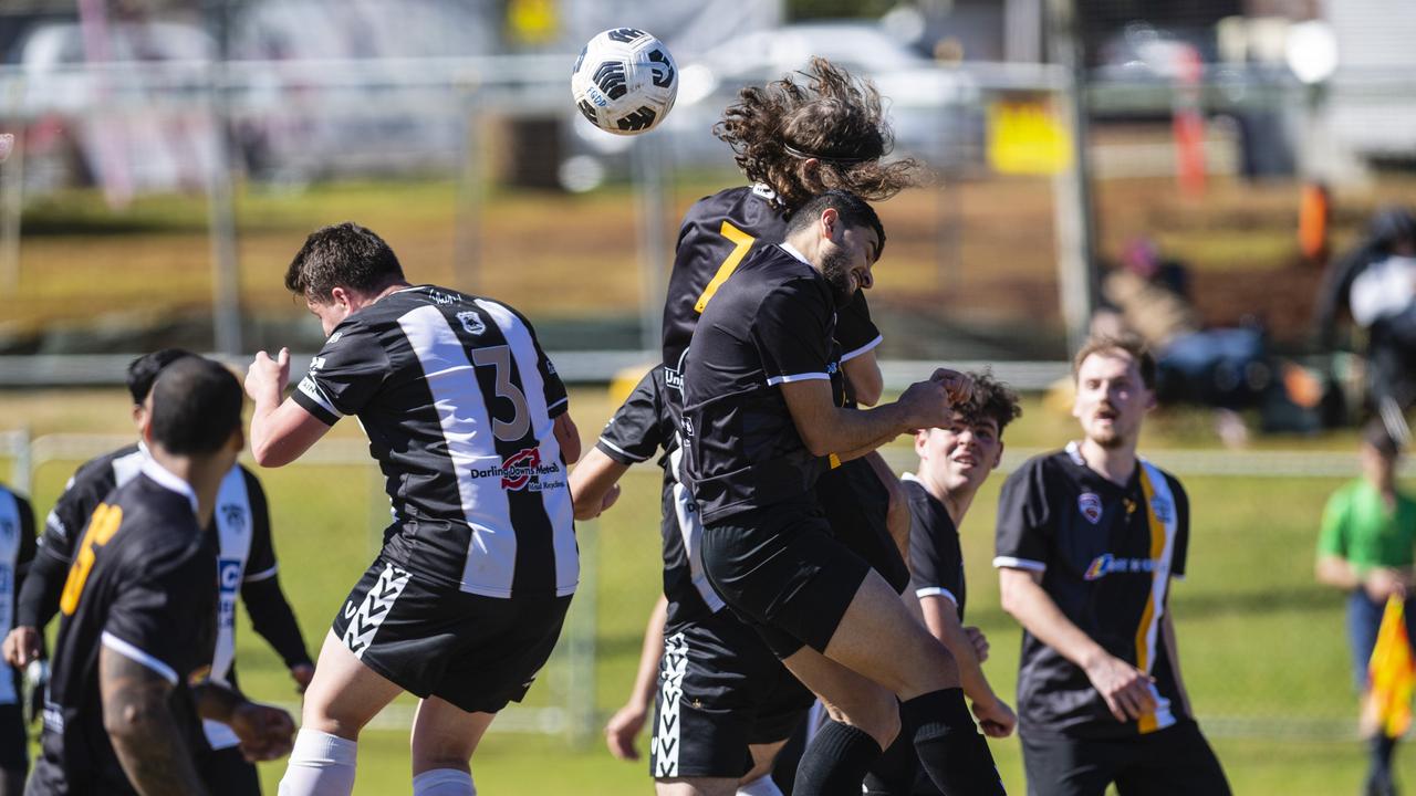 Willowburn player Kieran Antell (left) competes with Jack Norton and Mishaal Tamar of West Wanderers in U23 men FQ Darling Downs Presidents Cup football at West Wanderers, Sunday, July 24, 2022. Picture: Kevin Farmer