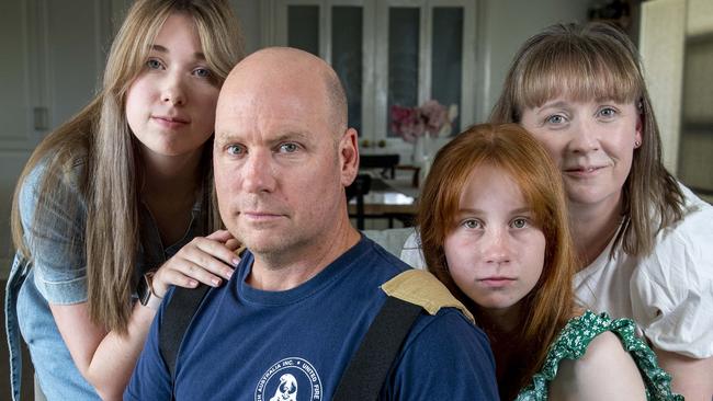 Fire Fighter Gary Marsh with his wife Shani and daughters Teiana  ,17,and Isla,13 with their dog Bernie an Aussie Mountain Doodle at their Fairview Park home.Wednesday,January,29,2025.Picture Mark Brake