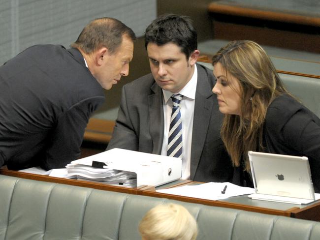 Ms Credlin speaks with Tony Abbott in parliament.