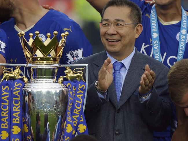 FIEL - In this May 7, 2016, file photo, Vichai Srivaddhanaprabha applauds beside the trophy as Leicester City celebrate becoming the English Premier League soccer champions at King Power stadium in Leicester, England. Thai billionaire and Leicester City owner Srivaddhanaprabha, who died when his helicopter crashed in a parking lot next to the soccer club's stadium, was known to fans as a smiling, benevolent man who gave away free beers and hot dogs on his birthday and brought the club its fairytale English Premier League title in 2016. He was 60. (AP Photo/Matt Dunham, File)