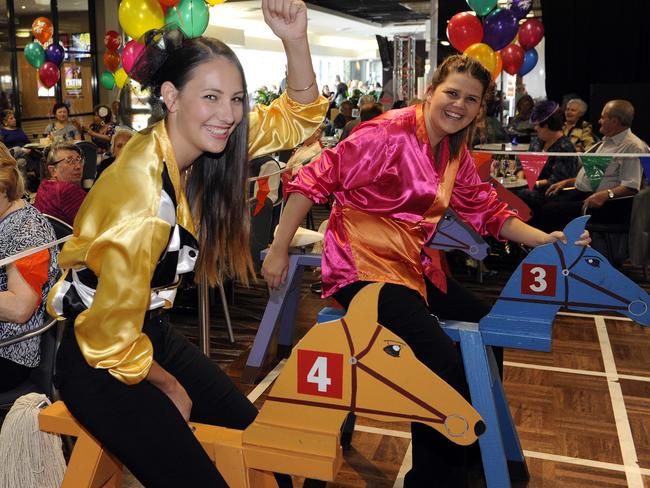 Kaila Truman and Sarah Thomas compete in wooden horse races at Melbourne Cup celebrations at The Juniors at Kingsford. Picture: Craig Wilson