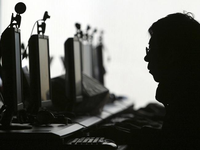 FILE - In this Jan 23, 2008 file photo, a computer user is silhouetted with a row of computer monitors at an Internet cafe in Shenyang, in northern China's Liaoning province. Word leaked out slowly, spread by tech-savvy folks on Twitter: Internet porn is now openly available in China. Is the new access to online pornography a policy change or a trap? It throws into sharp relief what many see as the main mission of China's aggressive Internet censorship: blocking content that might challenge the political authority of the communist government. (AP Photo/File) **CHINA OUT **