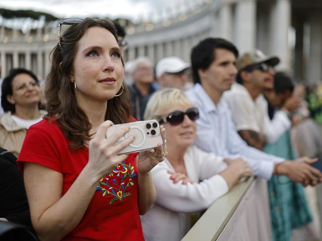 People watch and wait before black smoke was seen from the chimney of the Sistine Chapel meaning a new pope is not yet elected. Picture: Getty Images