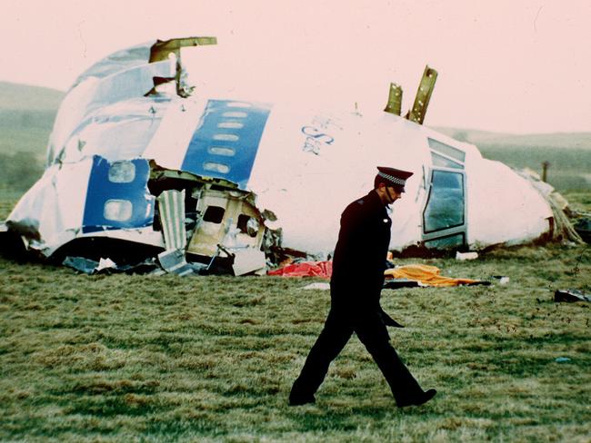 A policeman walks past the nose of the exploded jumbo jet in Lockerbie, Scotland in 1988.