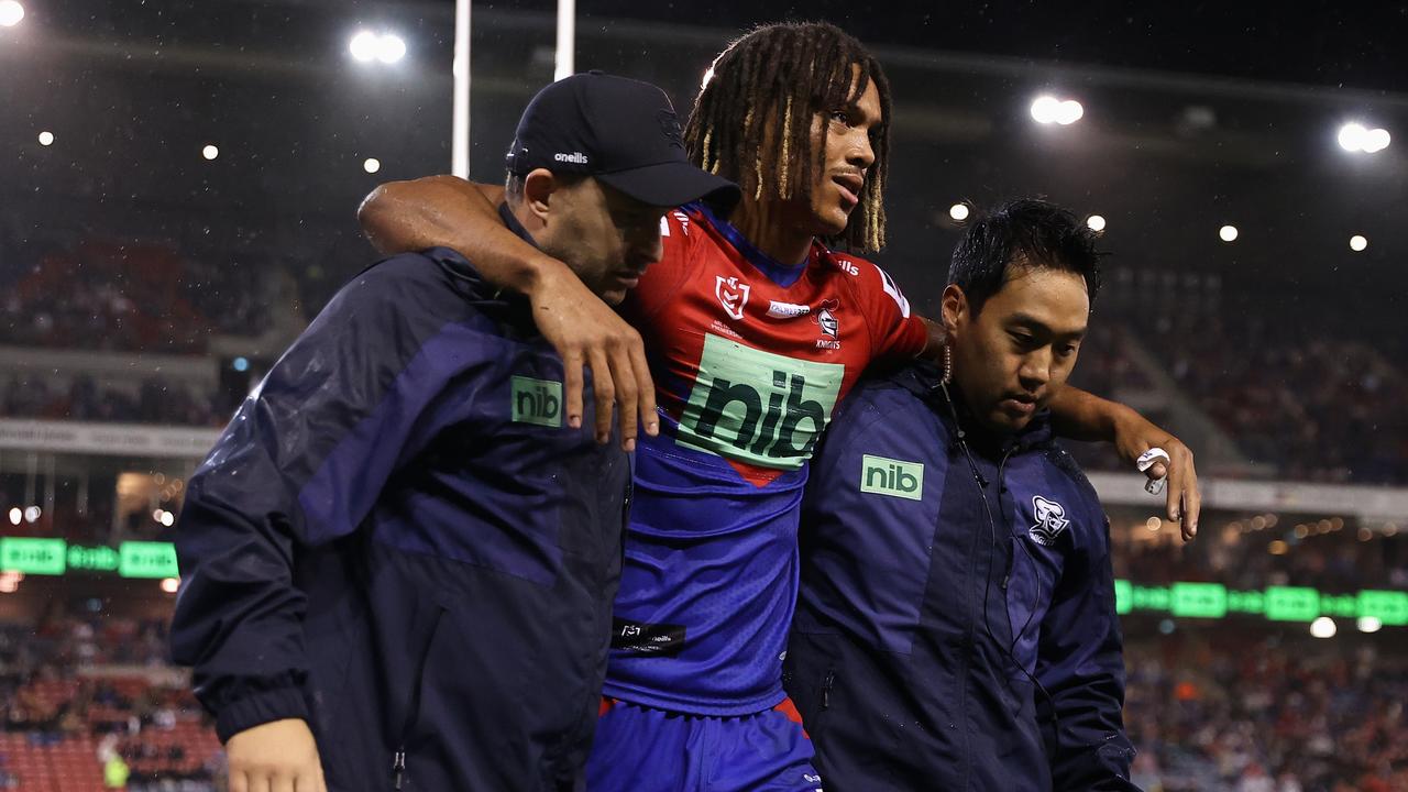 Dominic Young is assisted from the field with a knee injury. Picture: Getty Images