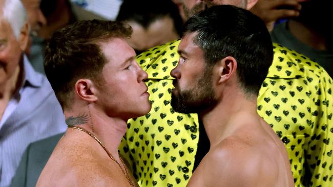 Mexican boxer Saul "Canelo" Alvarez (L) and British boxer John Ryder (R) face off during the weighing ceremony prior to their fight for the WBA, WBC, IBF and WBO super middleweight titles in Guadalajara, Mexico, on May 5, 2023. (Photo by ULISES RUIZ / AFP)