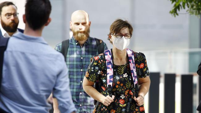 People in Brisbane seen wearing masks after Queensland raised its alert level to amber following a spike in Covid cases. Picture: Tertius Pickard