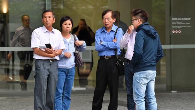 The family and friends of victim Jei "Jack" Lee are seen outside the Supreme Court in Brisbane (AAP Image/Darren England)