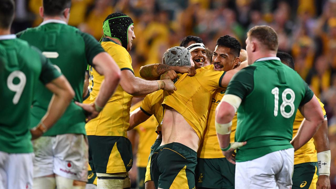 David Pocock (centre) of the Wallabies celebrates scoring a try with teammates against Ireland at Suncorp Stadium in Brisbane, Saturday, June 9, 2018.