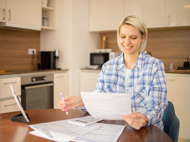 Woman is organizing finances and the household budget; ; income tax return bills generic