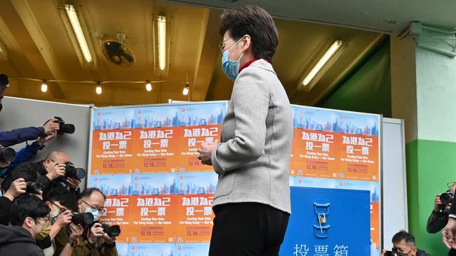 Hong Kong leader Carrie Lam leaves a polling station after casting her vote on Sunday. Picture: AFP