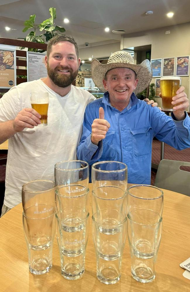 Walloon Hotel owner Stewart Gibson toasts with local legend Scotty who returned a number of glasses to the hotel. Picture: Walloon Hotel