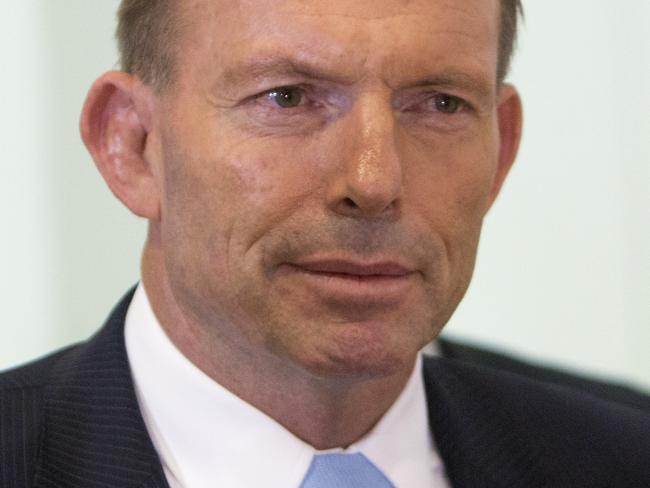 Australian Prime Minister Tony Abbott leaves a meeting of the ruling Liberal Party Monday, Feb. 9, 2015. Beleaguered Prime Minister Abbott survived an internal government challenge to his leadership on Monday, despite a revolt by dozens of colleagues that leaves him politically damaged. (AP Photo/Andrew Taylor)