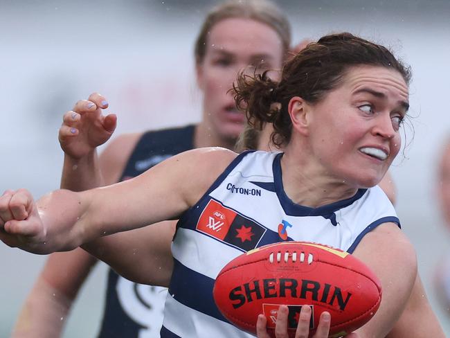 MELBOURNE, AUSTRALIA - SEPTEMBER 14: Meghan McDonald of the Cats handballs during the round three AFLW match between Carlton Blues and Geelong Cats at Ikon Park, on September 14, 2024, in Melbourne, Australia. (Photo by Daniel Pockett/Getty Images)