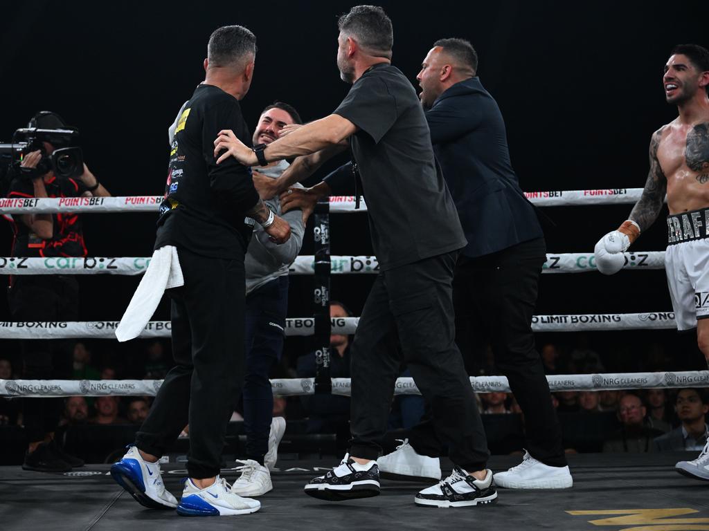 Tommy Mercuri (l) is struck by Michael Zerafa’s brother Jason post-fight. Picture: No Limit Boxing.