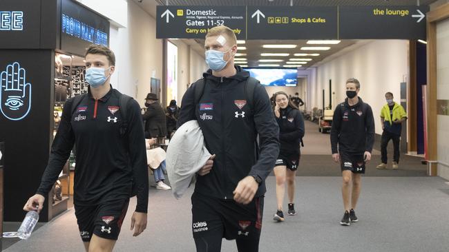 Essendon players board a plane for Perth at Tullamarine airport on Wednesday. Picture: NCA NewsWire / Luis Enrique Ascui