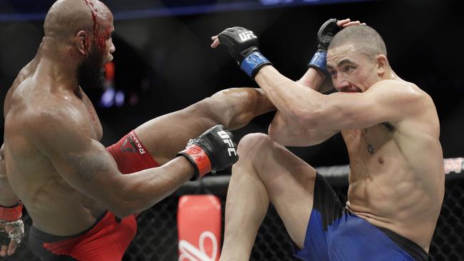 Yoel Romero kicks Robert Whittaker during their middleweight championship fight.