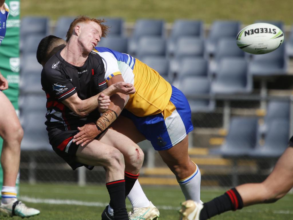 Endeavour halfback Lewis Sargent-Wilson gets crunched during the Peter Mulholland Cup grand final between Patrician Brothers Blacktown and Endeavour Sports High. Picture: Warren Gannon Photography