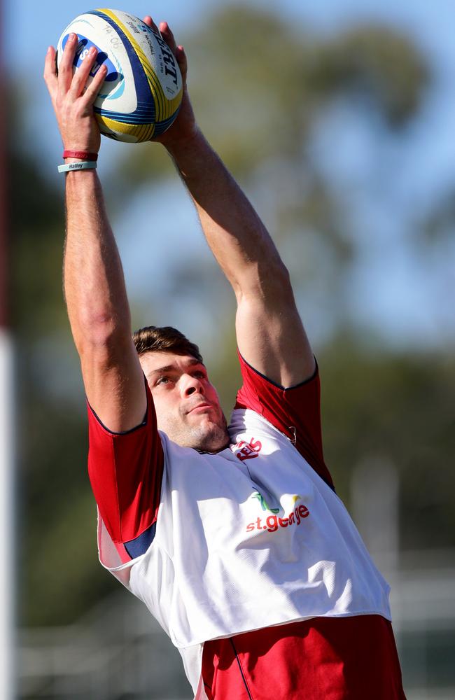 Tim Buchanan jumps for a ball at Reds training.