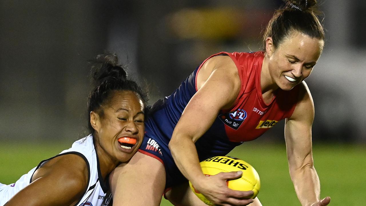 Daisy Pearce is tackled by Vaomua Laloifi as Melbourne withstands a late surge by Carlton. Picture: Getty Images