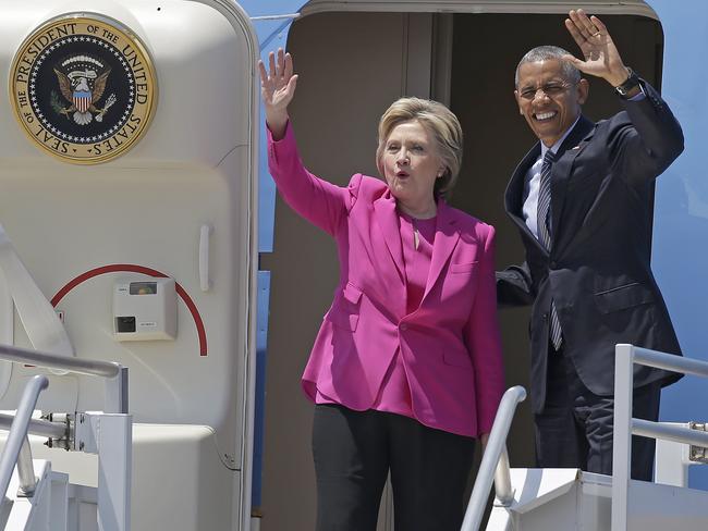 Democratic presidential candidate Hillary Clinton and President Barack Obama wave as they come off Air Force One upon their arrival at Charlotte, North Carolina.  Picture:  AP