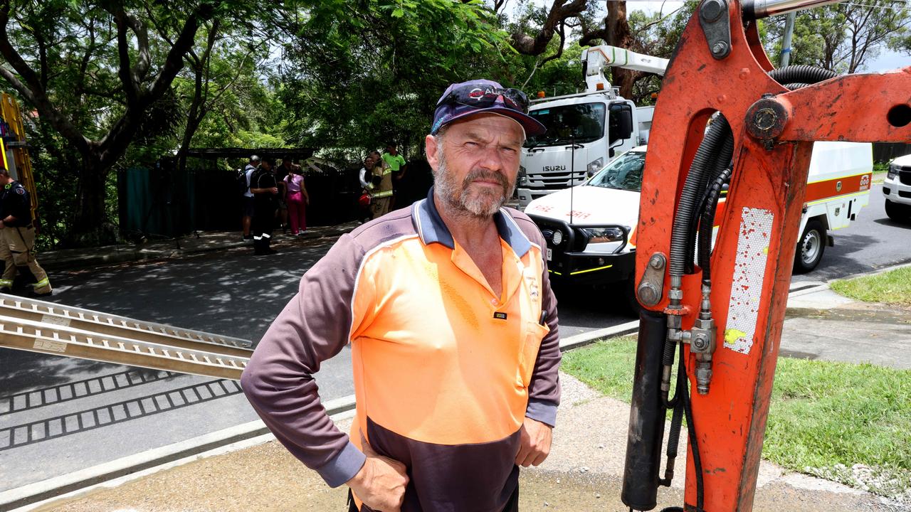 Peter Skippen from Brisbane Mini Excavations carried the elderly owner out of the property. Picture: David Clark