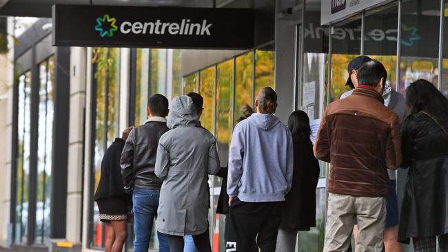 People queue outside a Centrelink office after being thrown out of work by the fallout from the coronavirus pandemic. Picture: AFP