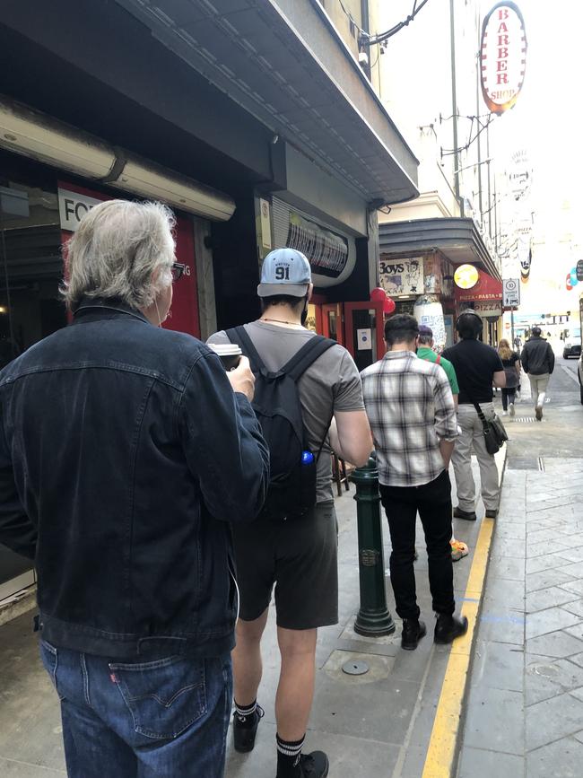 People queue for a haircut at Barber On Degraves.