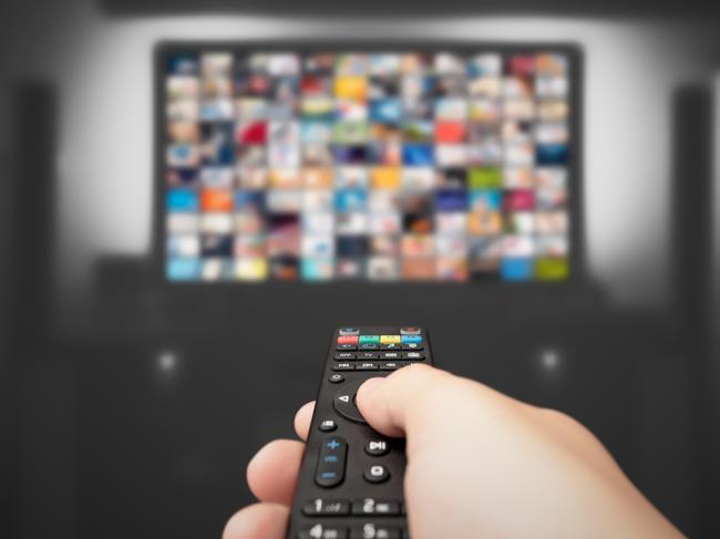 Video on demand, TV streaming, multimedia. Hand holding remote control