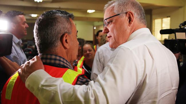 Morrison talks to a volunteer who has been affected by the fires. Picture: Aaron Francis