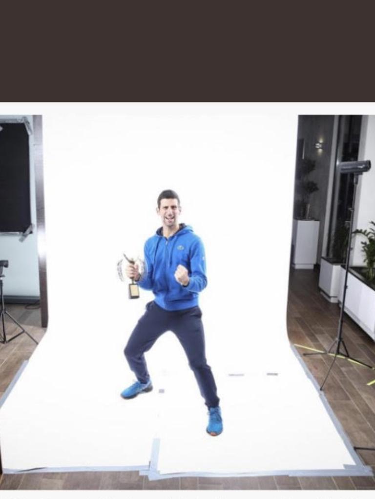 Djokovic posed without a mask during the presentation of the 'Champion of the Champions 2021' trophy on December 18. Picture: Etienne Garnier/L'Equipe